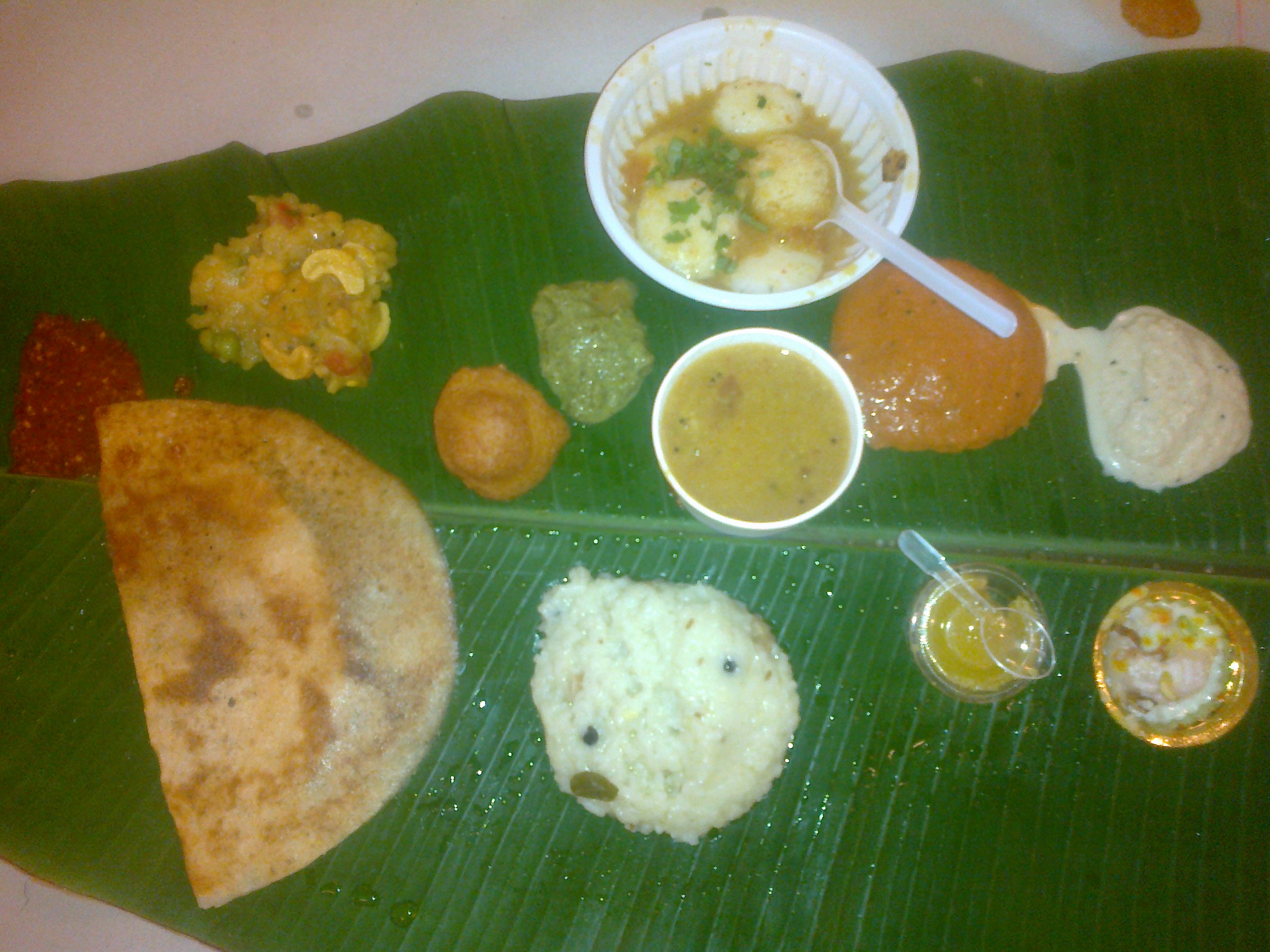 South Indian thali with dosa, rice, curries and chutneys served on a banana leaf